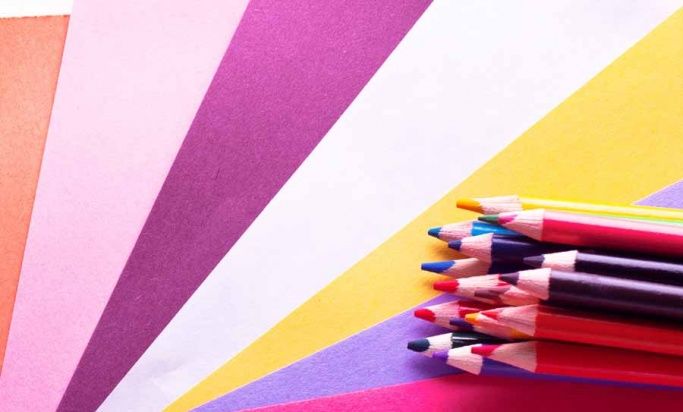 Pencils lying on a colourful background