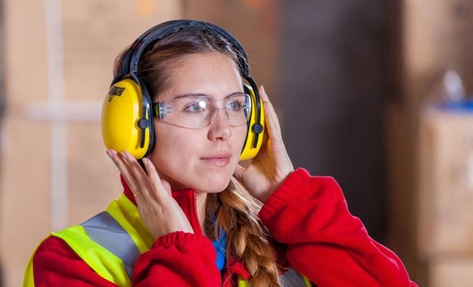 Woman apprentice wearing ear defenders