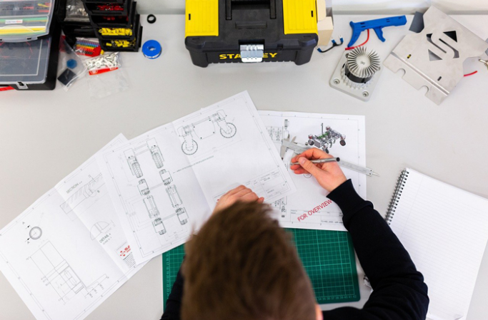 A designer at a desk with plans in front of her