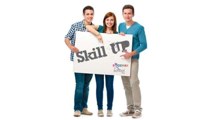 Three students holding up a sign