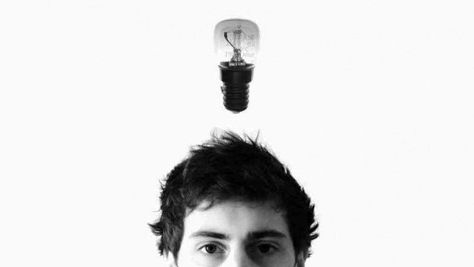 Light bulb above a young person's head representing using your initiative