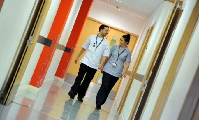 Two mental health nurses walking down a corridor