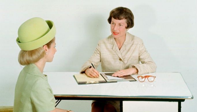 An old photo of two women doing an interview